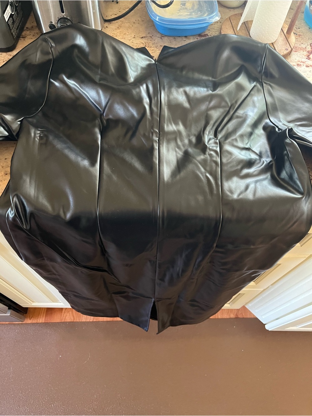Black Zip-Front Garment Packed in Clear Sleeve